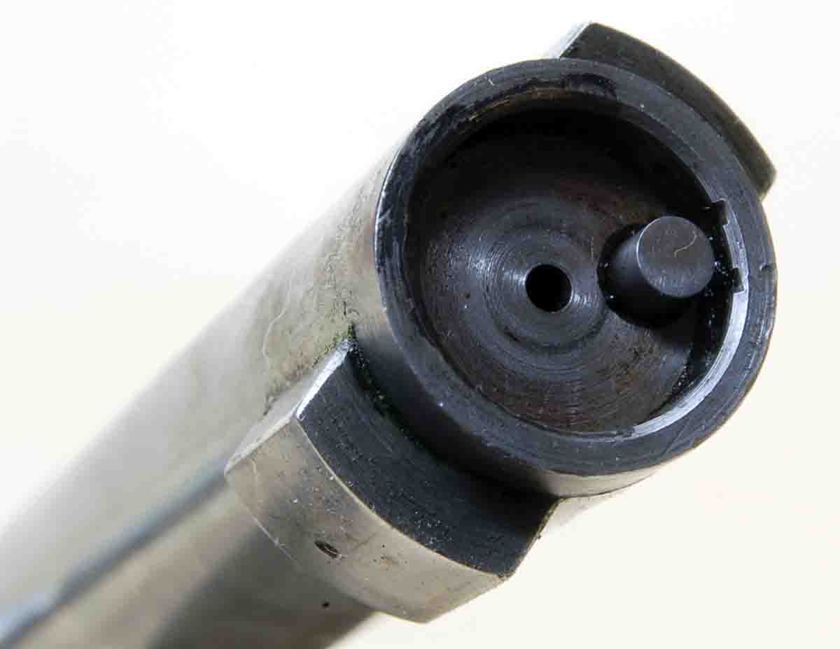 This Remington bolt face shows the cartridge base recess for the belted-magnum case and the thin rim of steel, in which the Remington extractor is enclosed. A larger-based case is impossible.